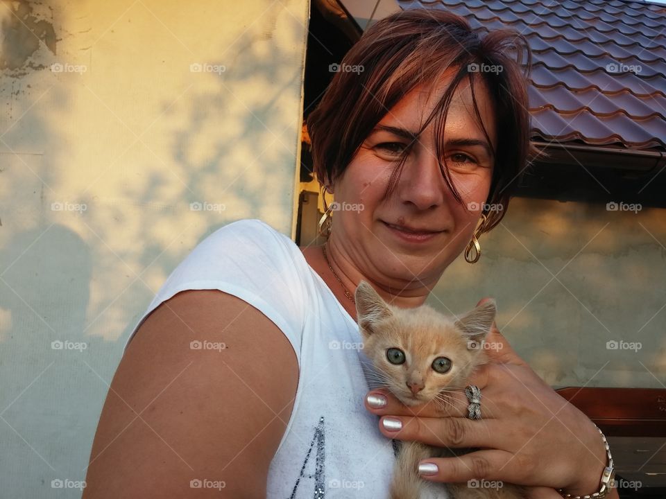 Portrait of woman with cat