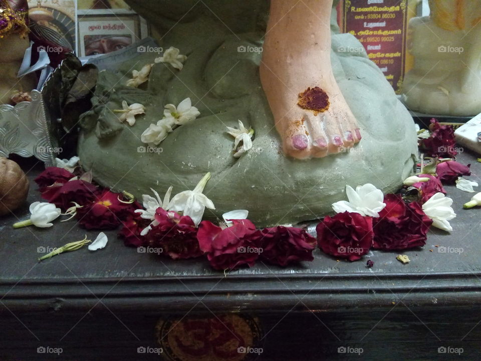 Flowers at Divine's feet