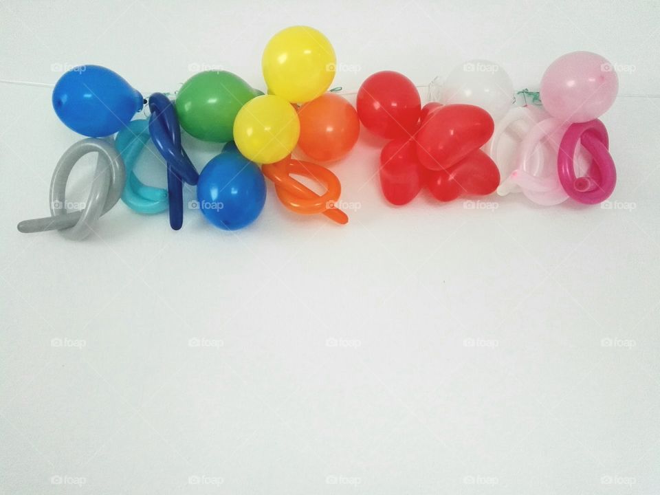 colorful balloons hanging on white wall