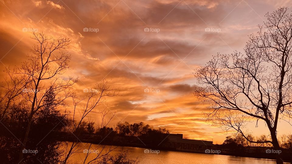 Due to a Cold Airmass Front and the clouds parted late at sunset. As the sun sets deeper into the Horizon Colors get deep and more colors are spread across the sky. 