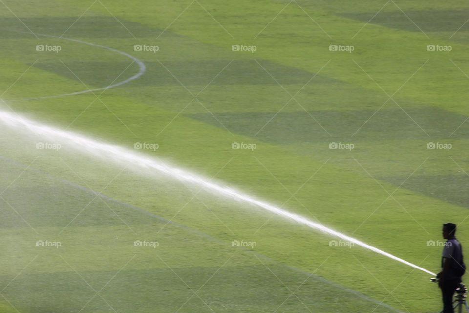 watering the grass before the game