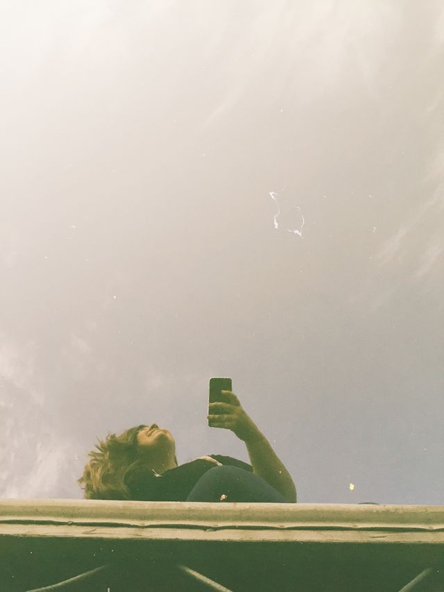Look to the sky. Seeing my reflection in the water, but wanting to look to the sky and dream. 