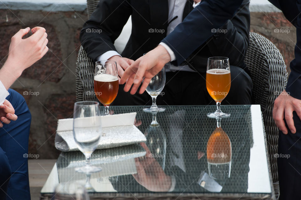 beer mugs and wine glasses on a dinner table at a party