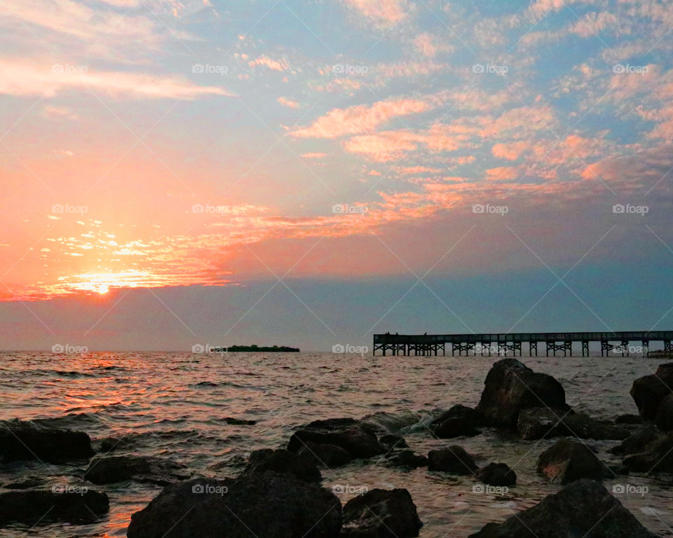 Sunset over a beach fishing pier