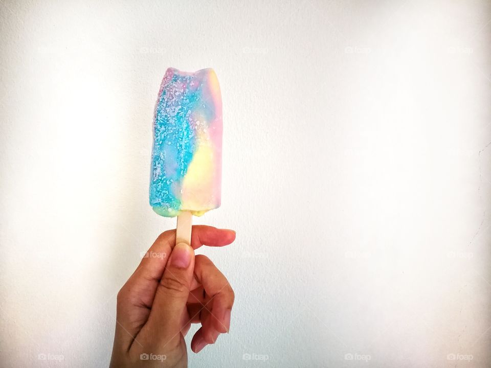 Colorful ice cream in human hand