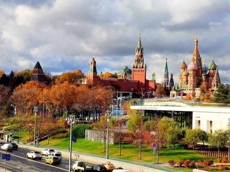 Moscow.  View of the Moskvoretskaya Embankment, Zaryadye Park, the Moscow Kremlin, St. Basil's Cathedral and the Spasskaya Tower.  Autumn trees