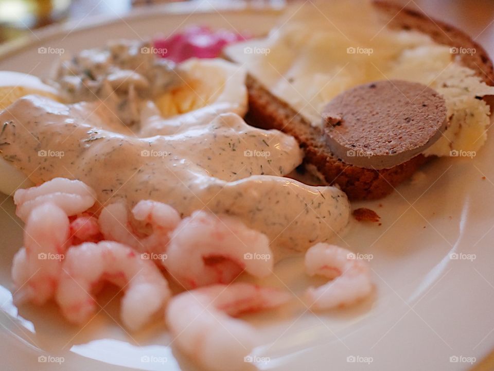 Shrimps, herring in tomato and sour cream sauce and eggs 