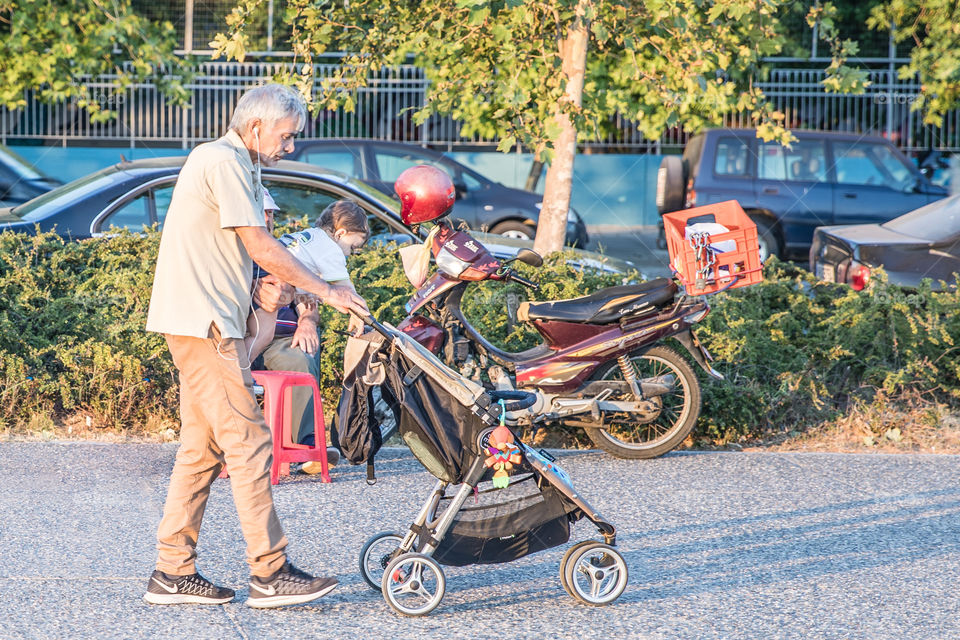 Grandparent Taking A Walk With His Grandchild
