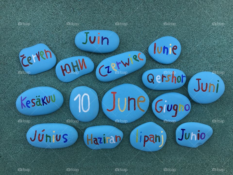 10  June, calendar date with colored stones over green sand