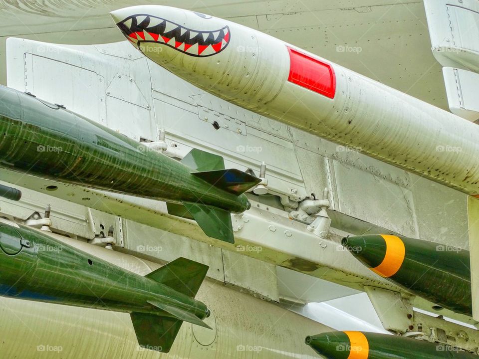 Bombs And Missiles Mounted On A NATO Warplane. Weaponry Mounted On A Military Aircraft
