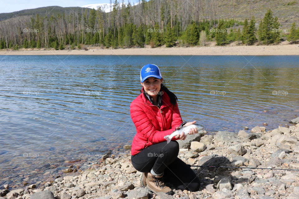 Girl fishing for trout in the Colorado mountains. 