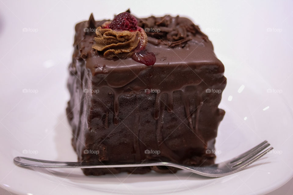 Chocolate mousse with raspberries on a white plate