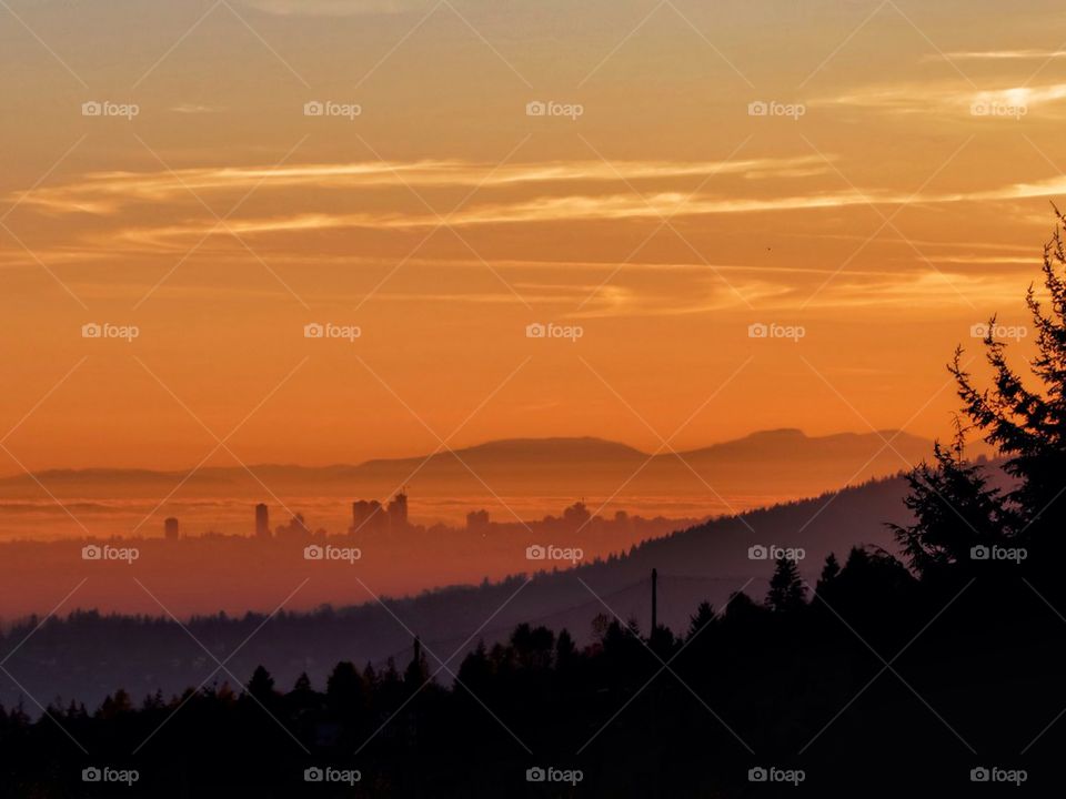 Foggy morning over city at hill