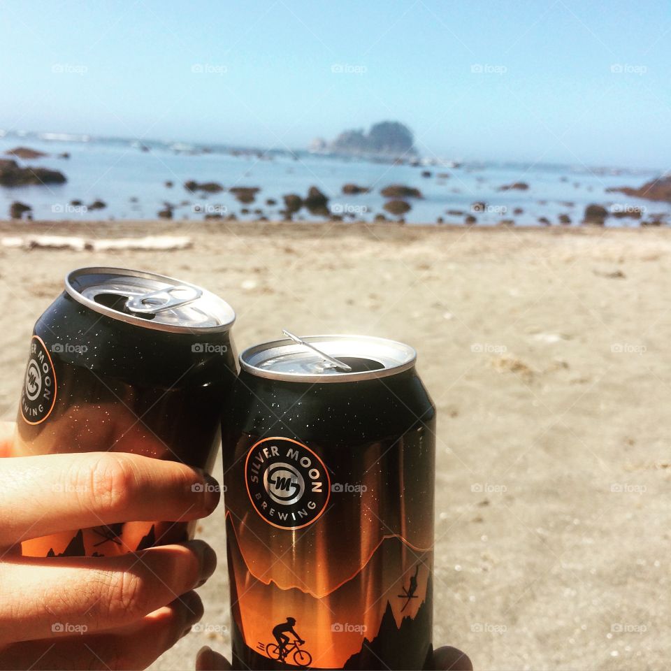 Cheers! Enjoying a beer while beach camping 