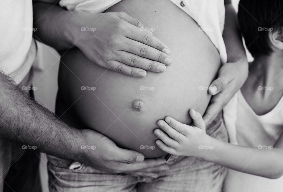 Mid section of pregnant woman with family