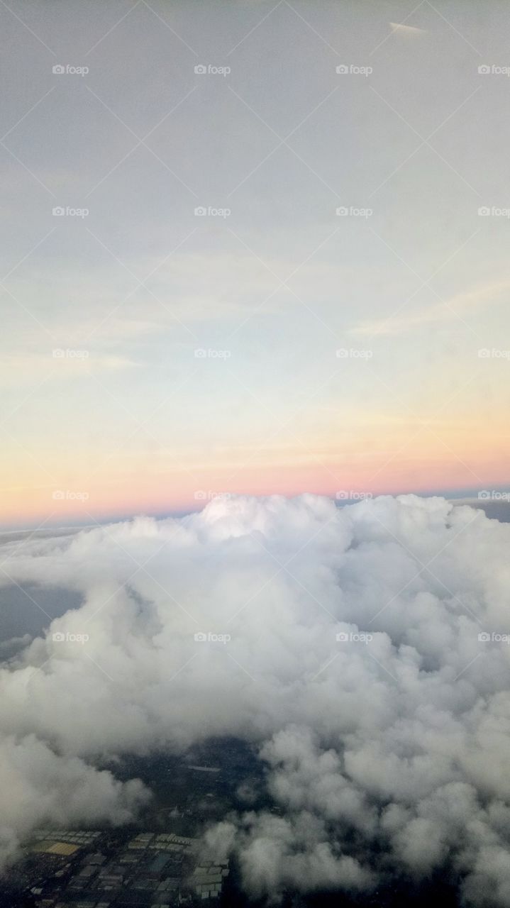 Beauty of clouds and sky. Rainbow, blue, white, nature, light, wavy view from above. 