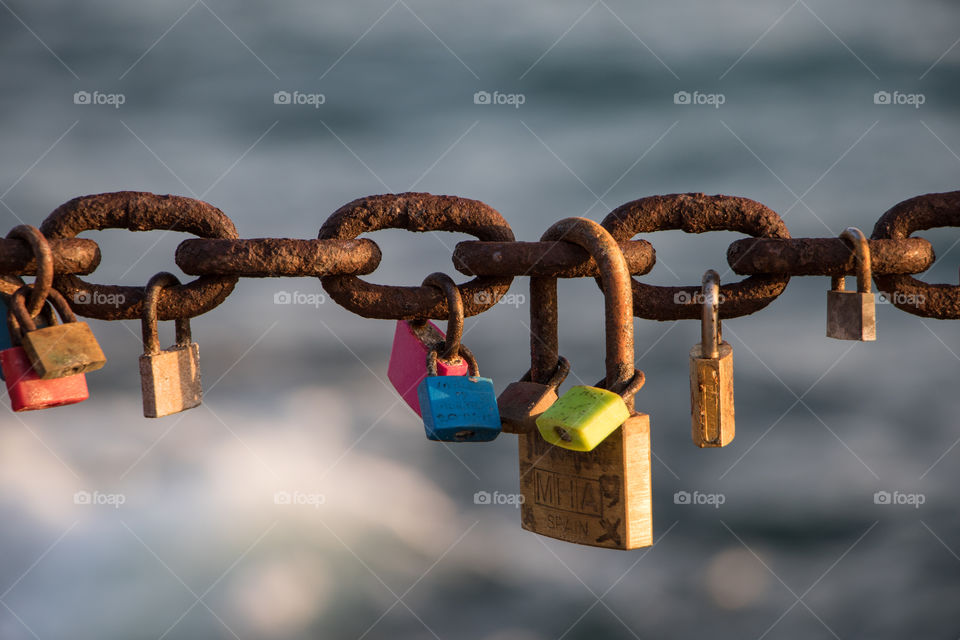 chain with locks of colors and the sea of background