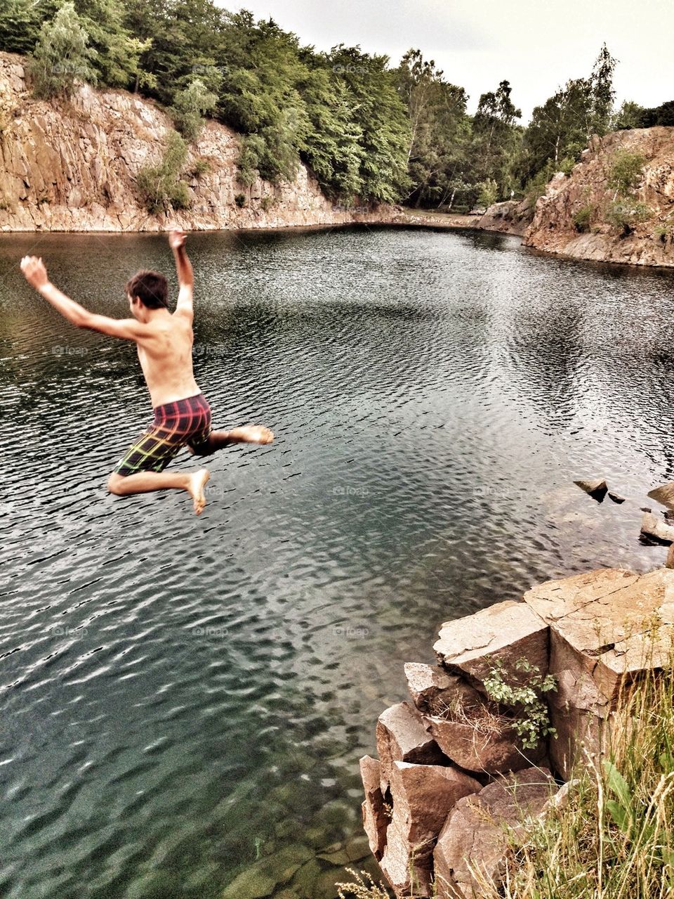 Boy from behind jumping