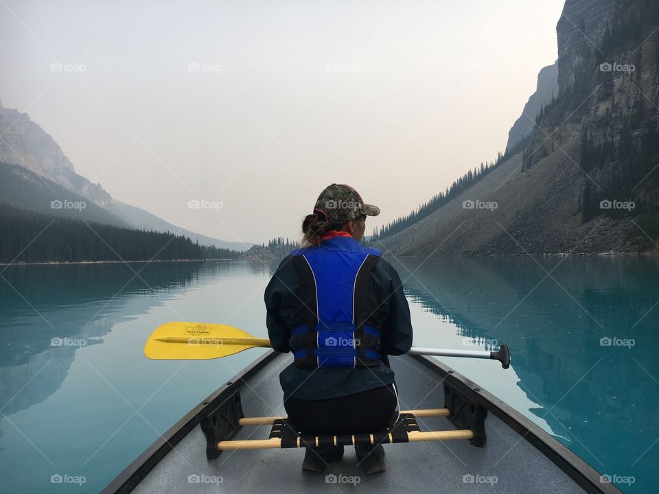 Girl canoeing on Moraine Lake in Alberta