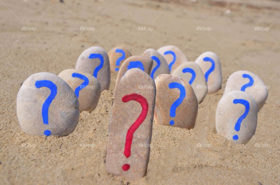 Red and blue color question marks on stones