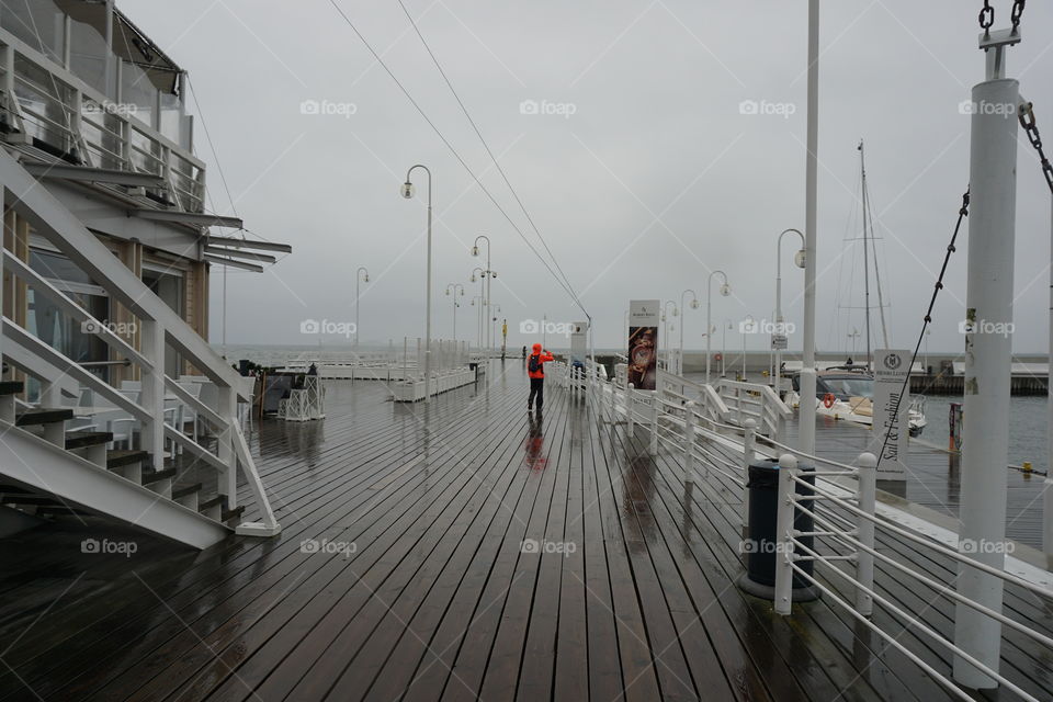 No. 8 .... Red colour effect ... Pouring with rain but the lady wearing a bright orange kagoule (nearly red) caught my eye as a lovely contrast against the wet wooden boards at the end of Sopot pier ... I love the reflection and the foggy background.