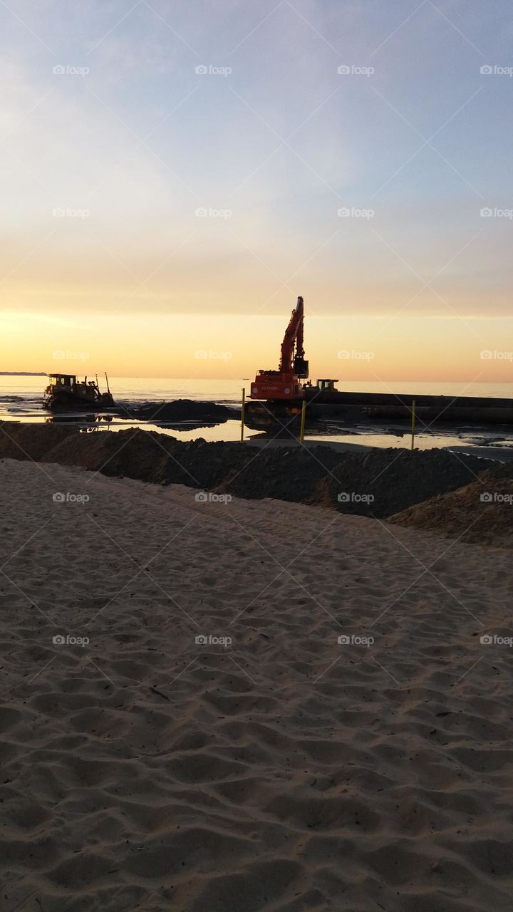 working evening on the beach excavator dredge beach reclamation