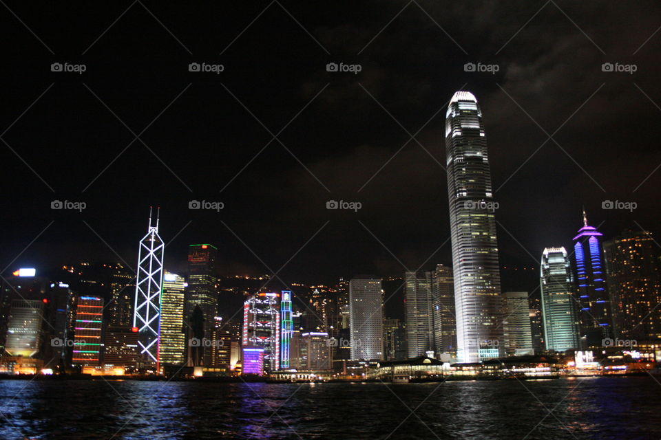 The skyscrapers of Hong Kong lit up at night.