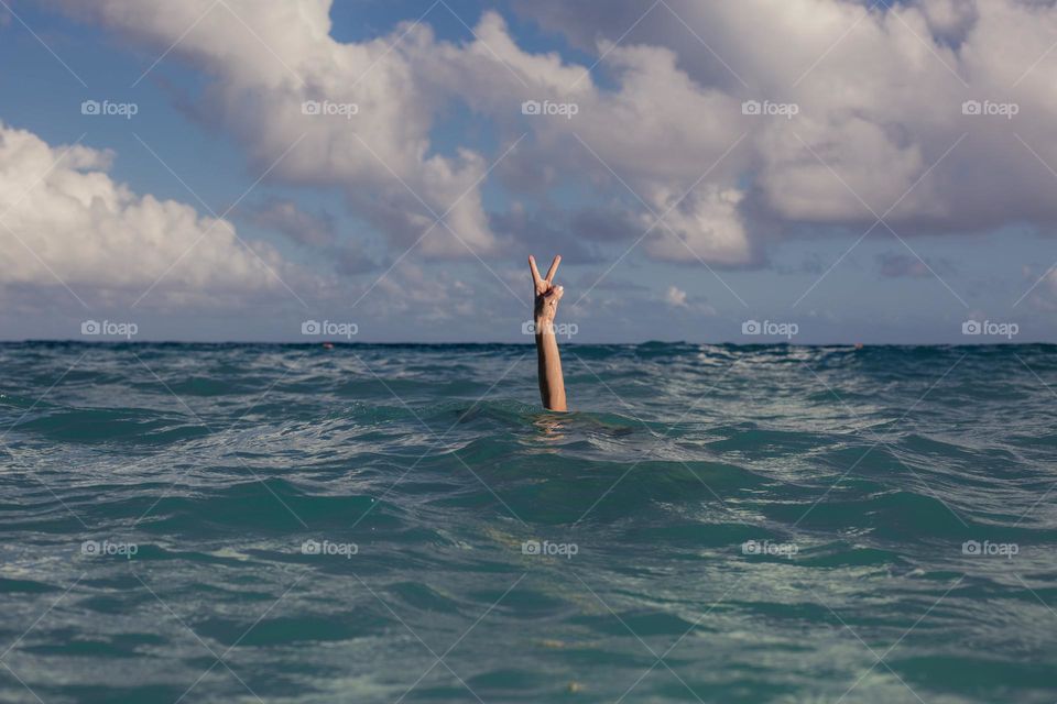 vacation peace sign in ocean