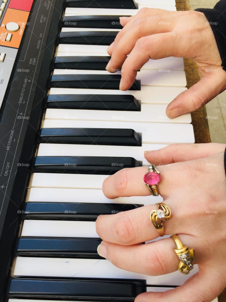 A girl is playing in the piano