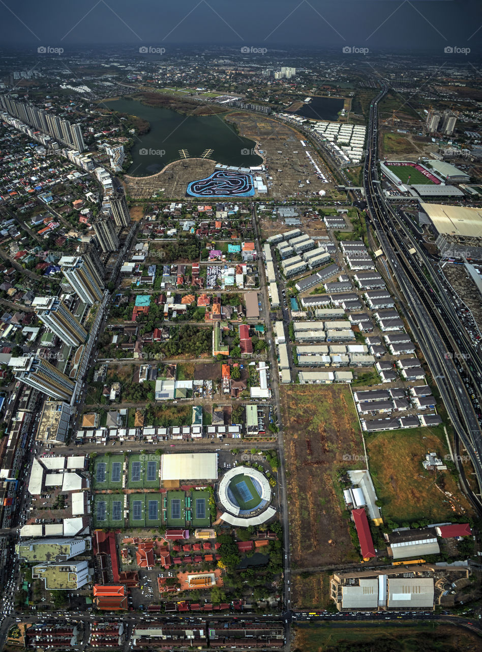 Bangkok taken with drone, high angle view showing tennis court,buildings condominium