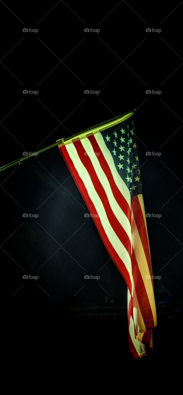 American flag flowing in the dark of night