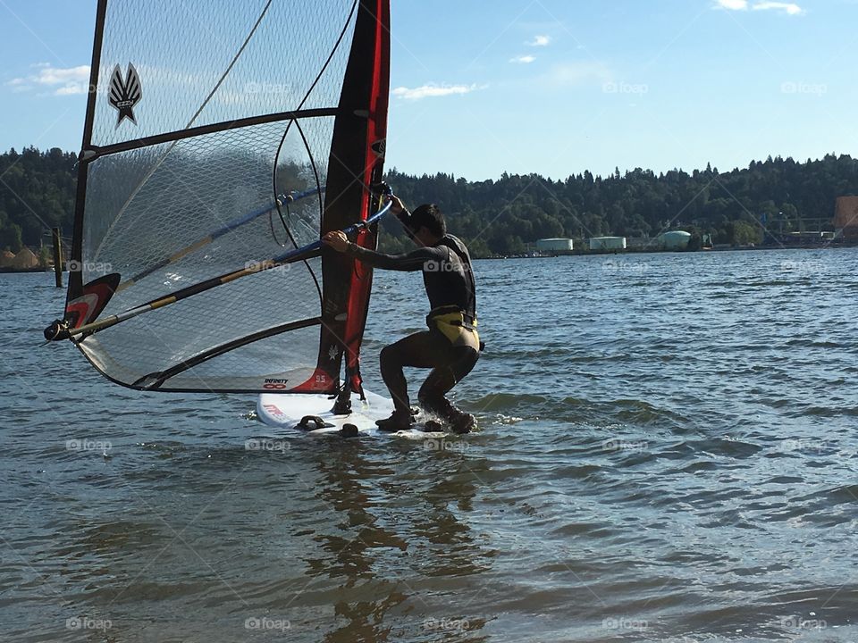 Man windsurfing in harbour closeup