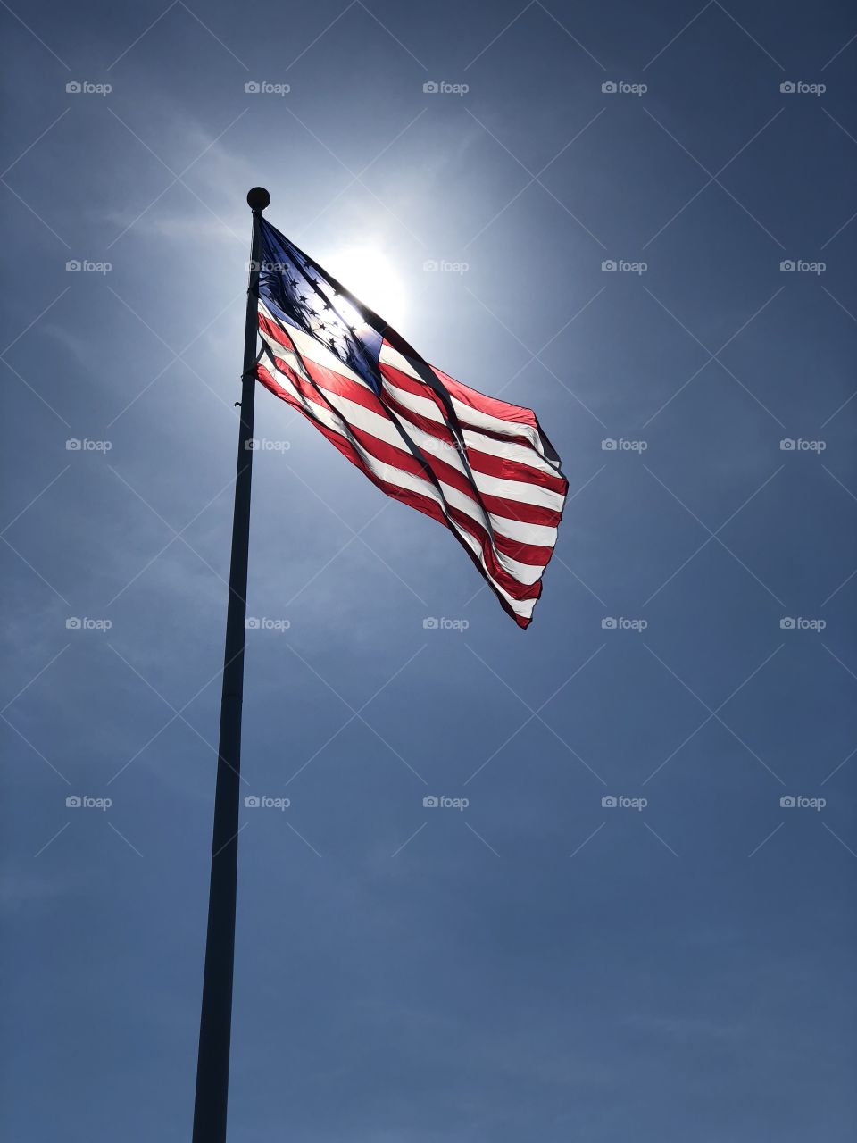 Sun behind old Glory