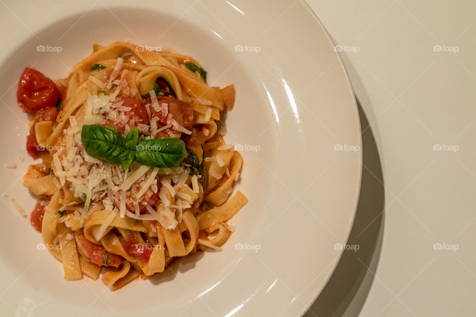 Close-up of fettuccine pasta garnished With grated cheese