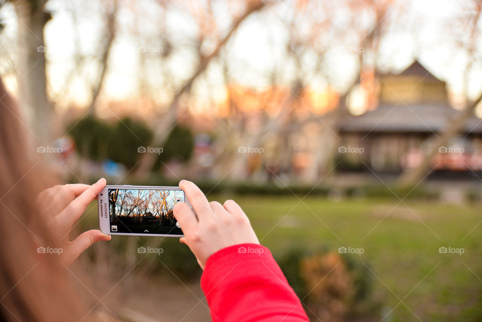 Girl taking a picture in the park