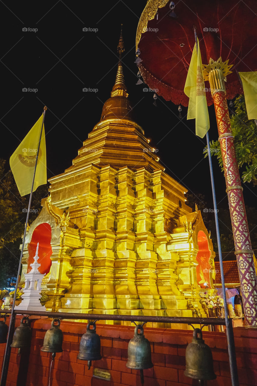 The very gold and geometric stupa of a Thai Buddhist temple in Chiang Mai 