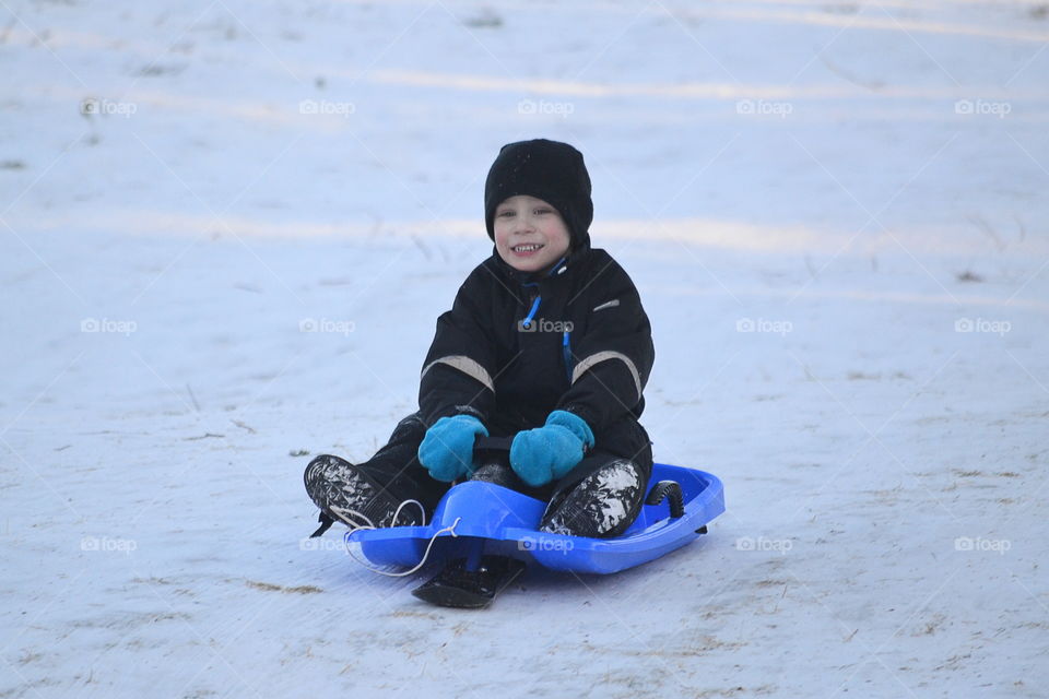 Boy enjoying on snowy landscape