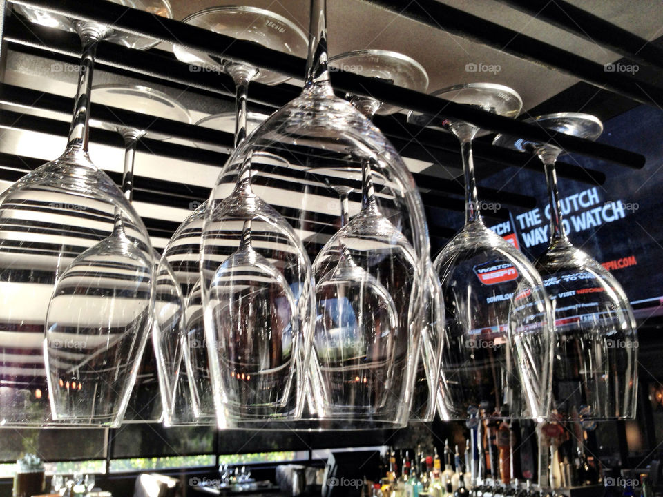 Wine glasses hanging on rack In a bar restaurant
