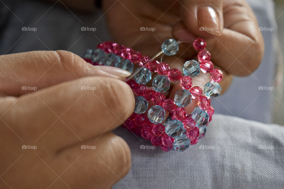 Close-up of a woman making bracelet