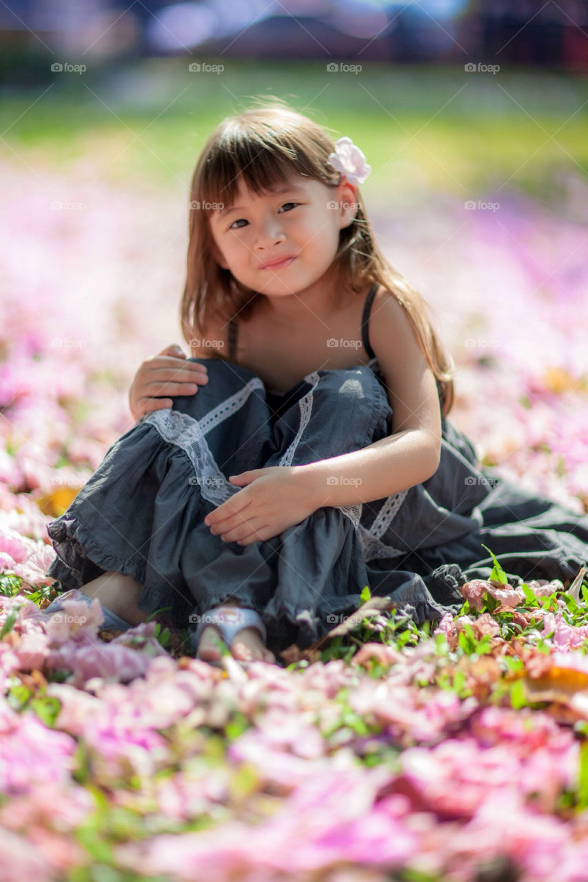 Cute Eurasian in a field of flowers