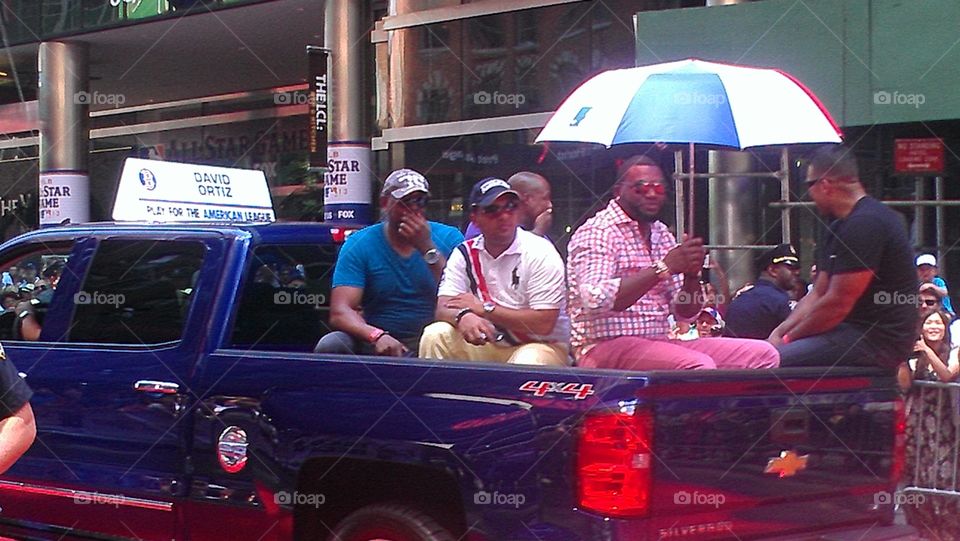 David Ortiz with umbrella. Hot Day for a parade 