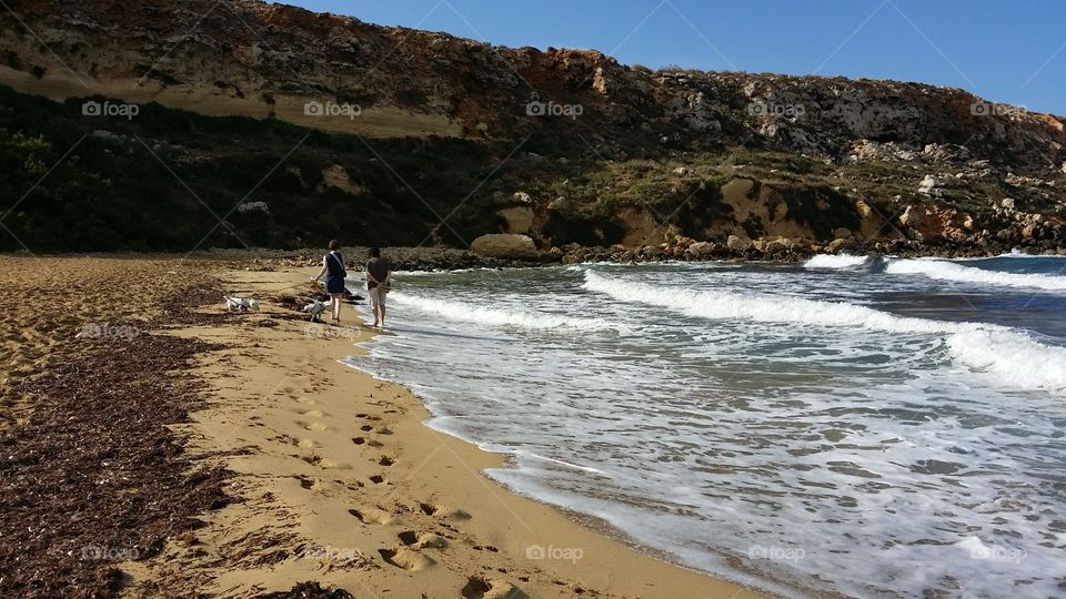 walking on the beach on a windy day