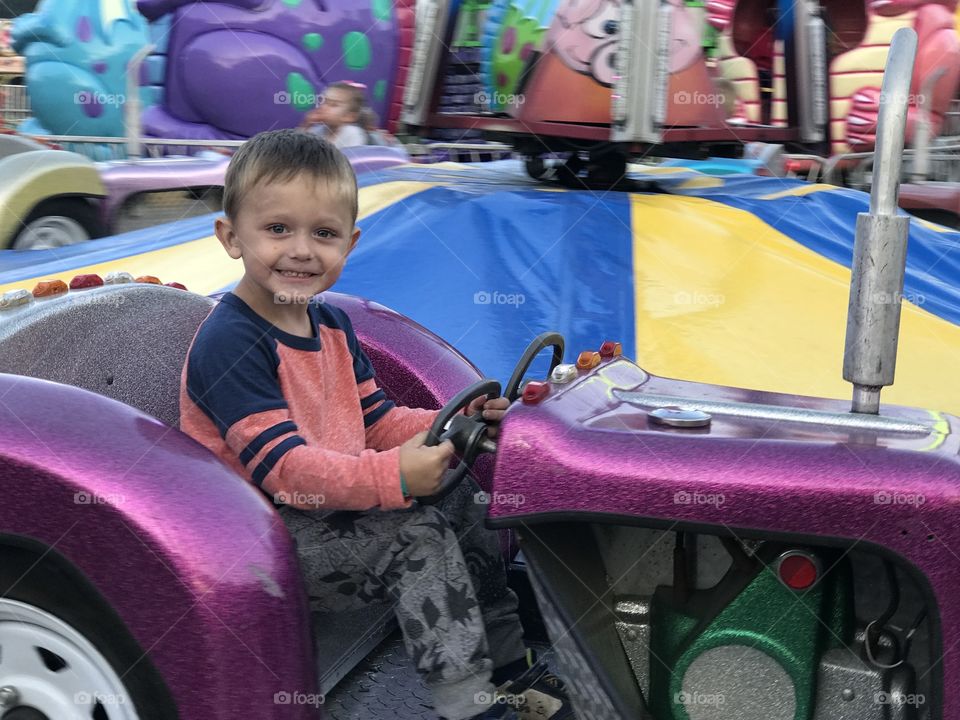 Little cutie driving his first car. 