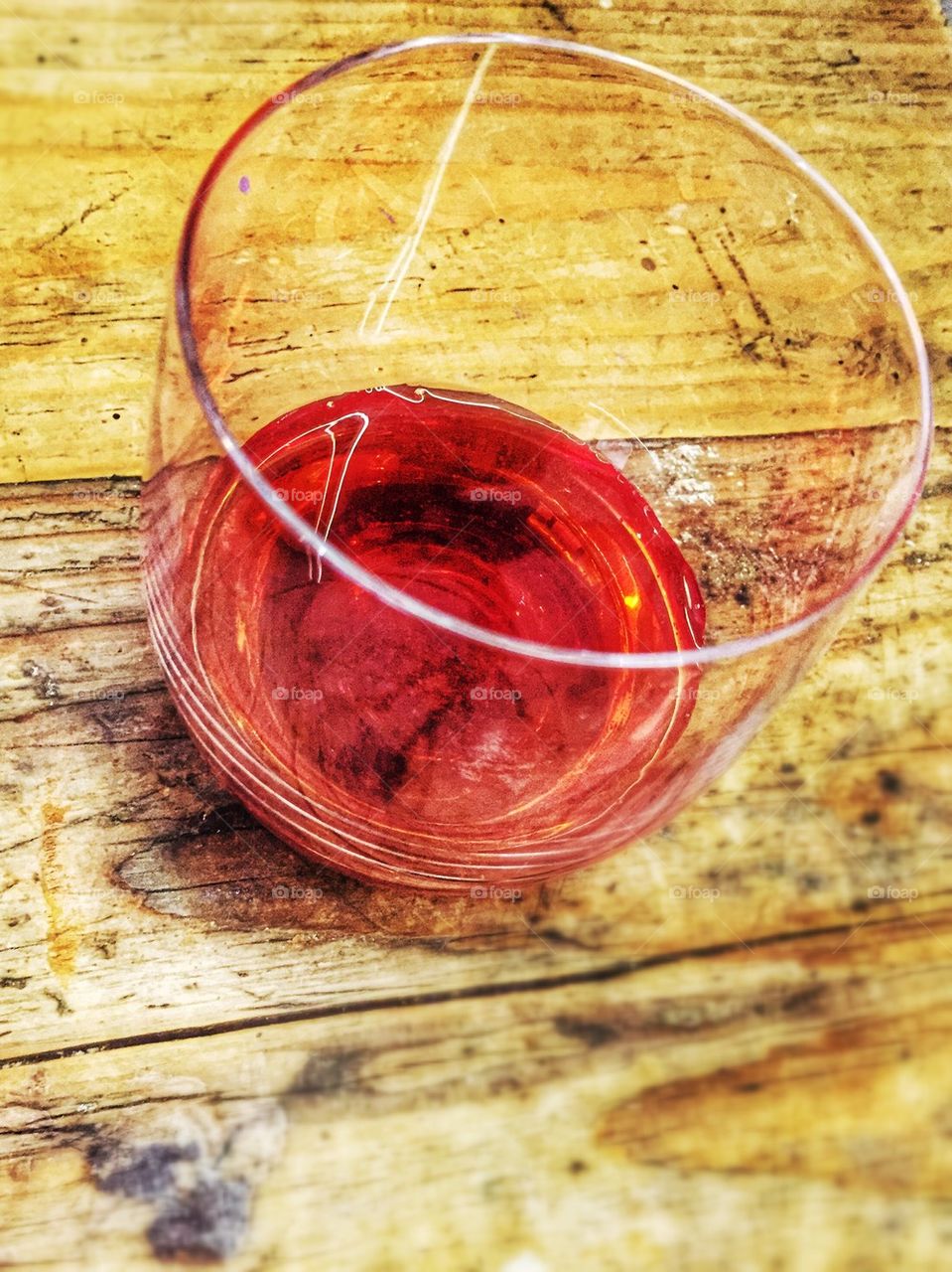 Red beverage on glass on old wooden table rustic