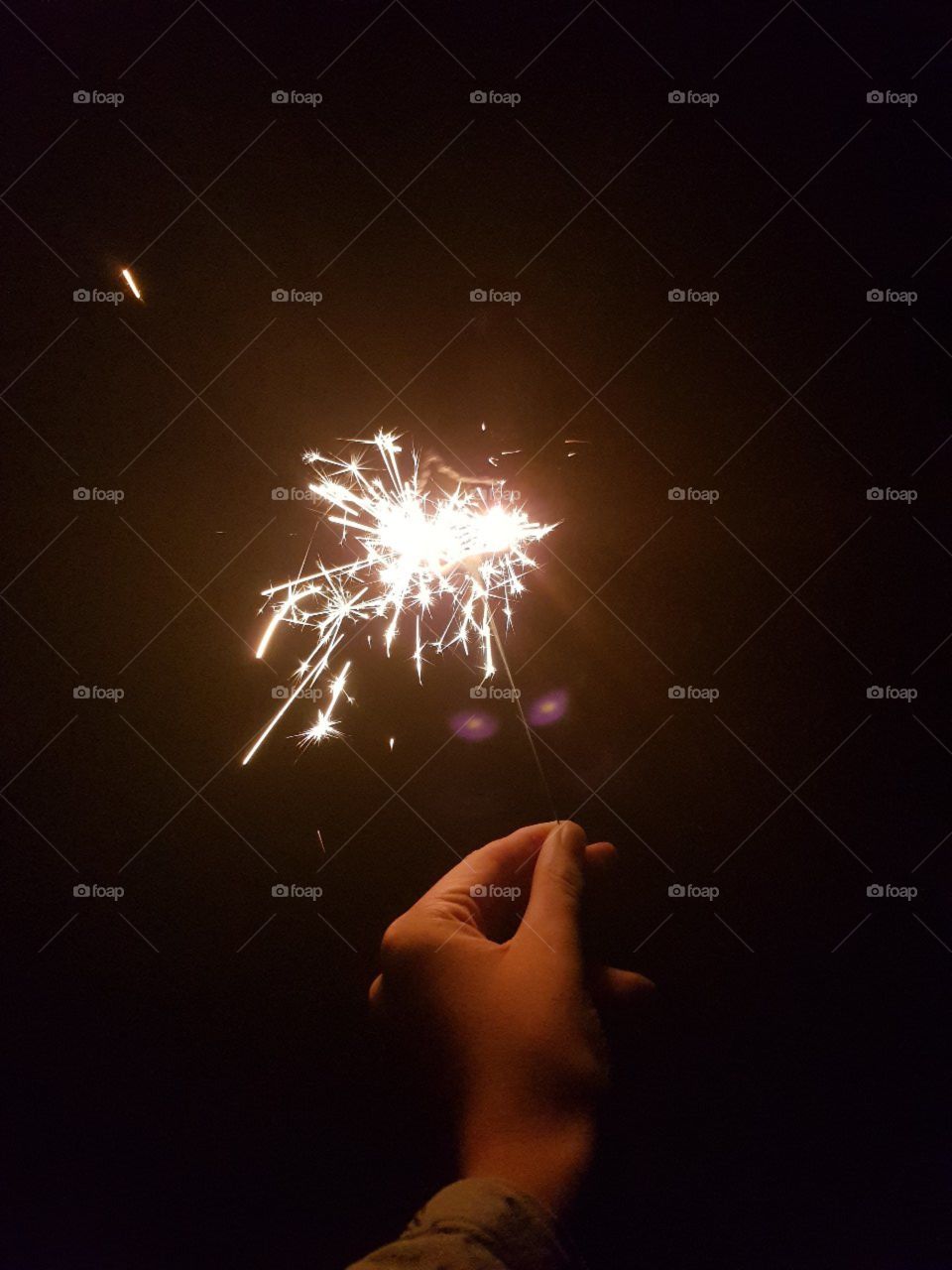 Sparkler In hand at night