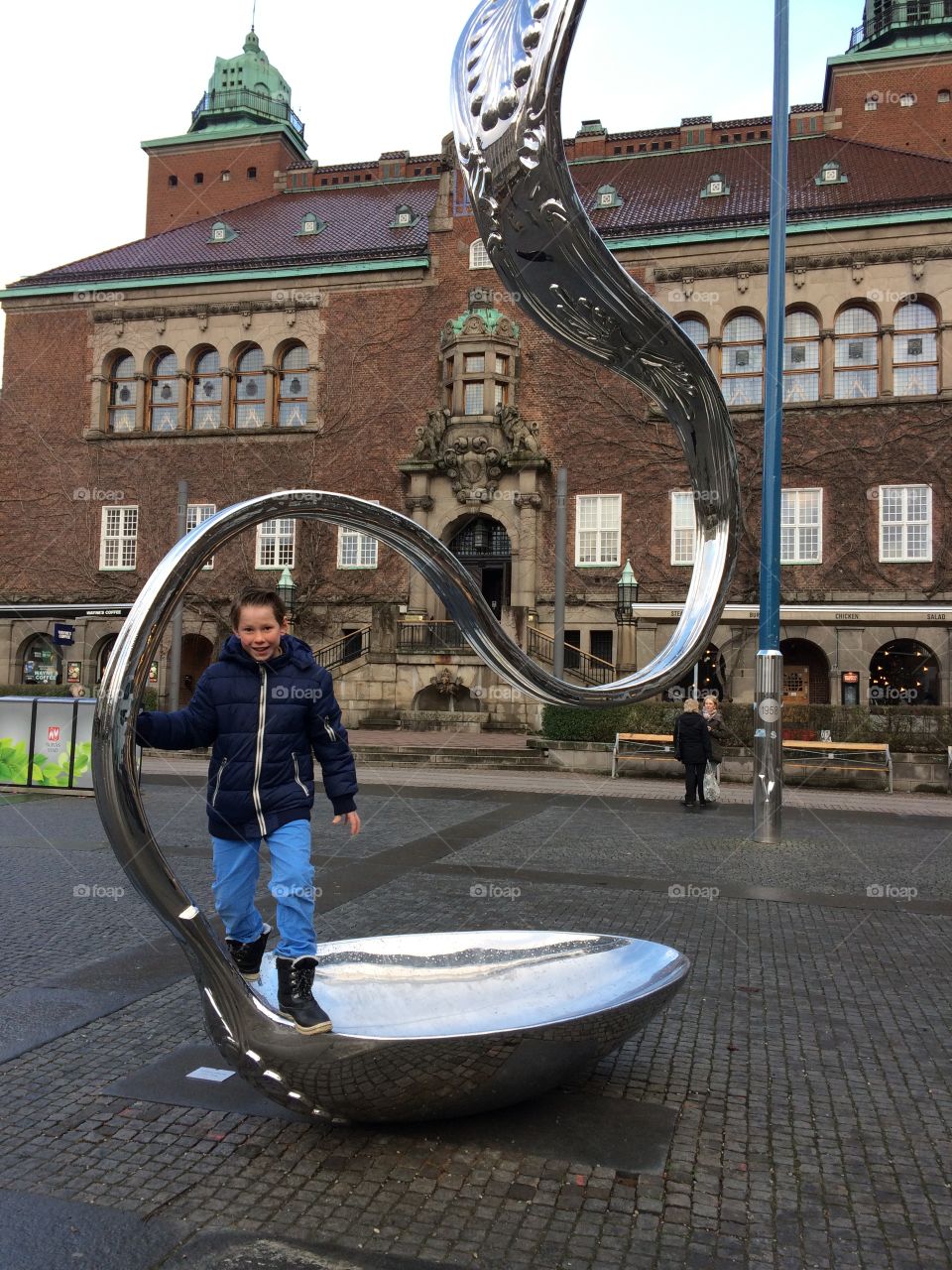 Boy standing on metallic structure