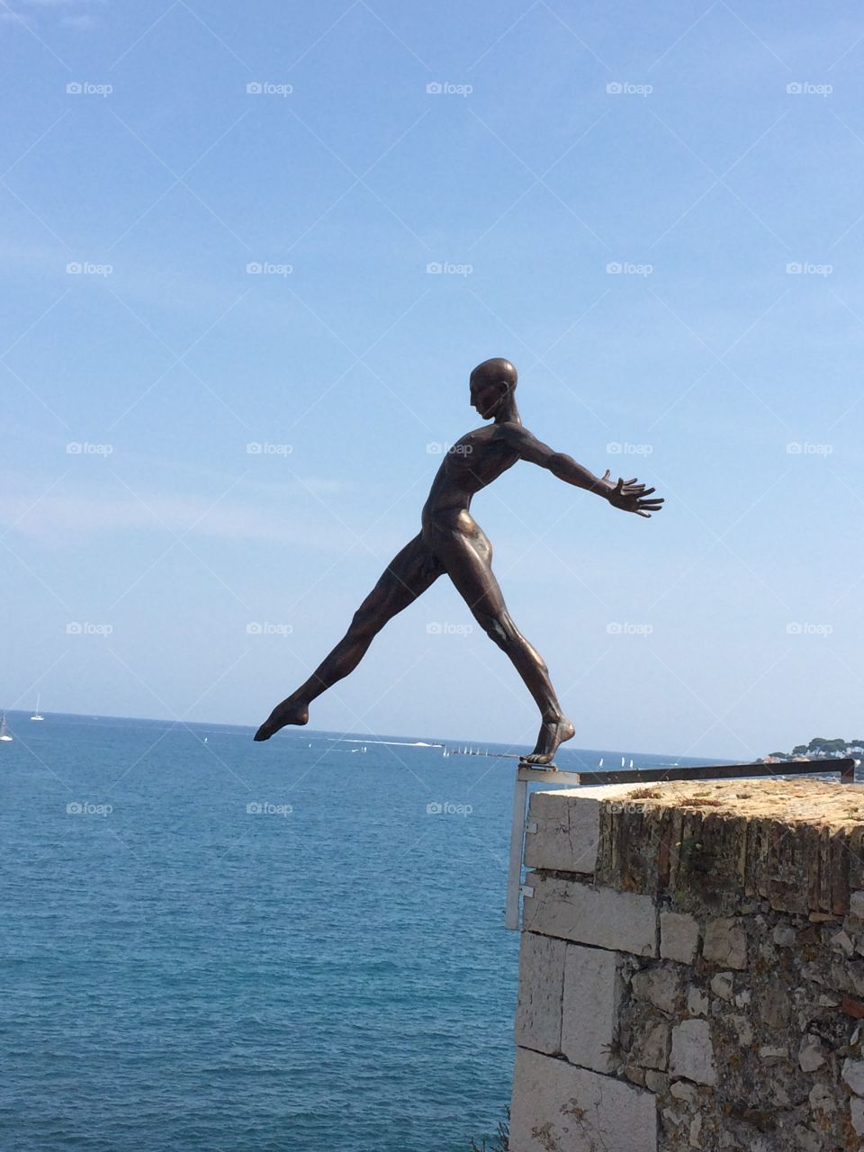 Antibes, France. Bronze statue overlooking the sea. 