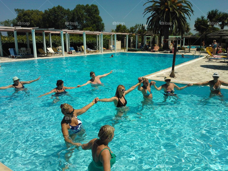 Female friends having fun in swimming pool