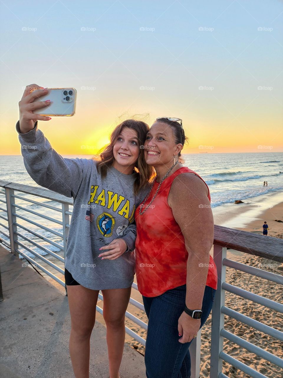 Beautiful ladies take a selfie with a setting sun backdrop