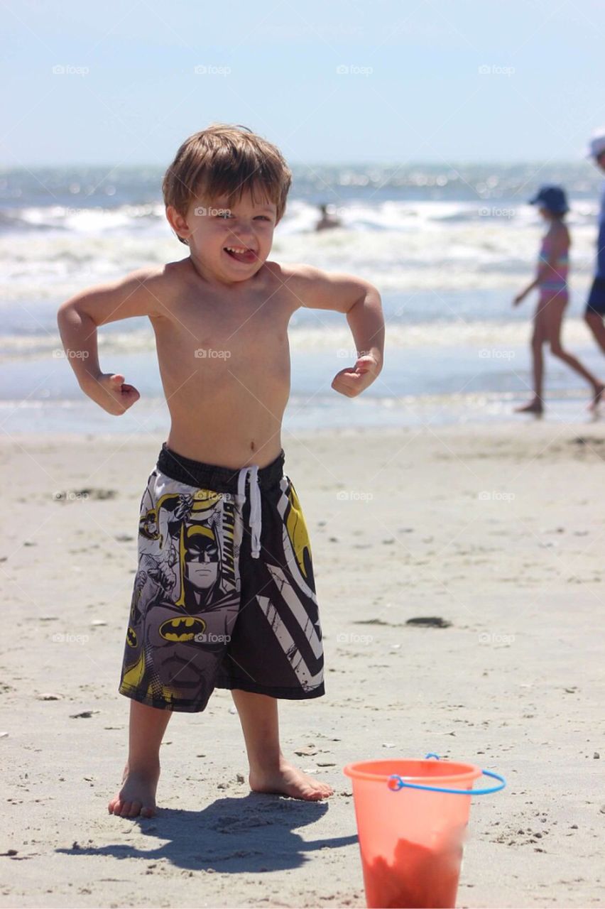 Small little boy posing at beach